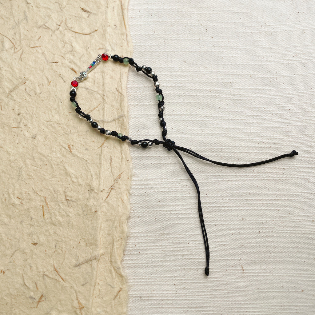 Handmade black cord bracelet with glass beads, minimalist boho soul jewelry.