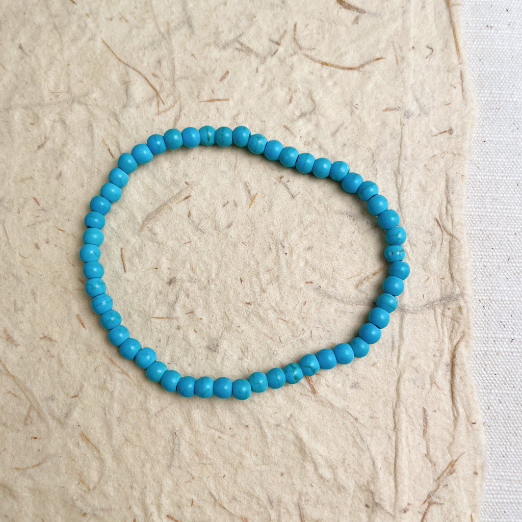 Natural turquoise gemstone bracelet on wrist, calming blue stone jewelry gift.