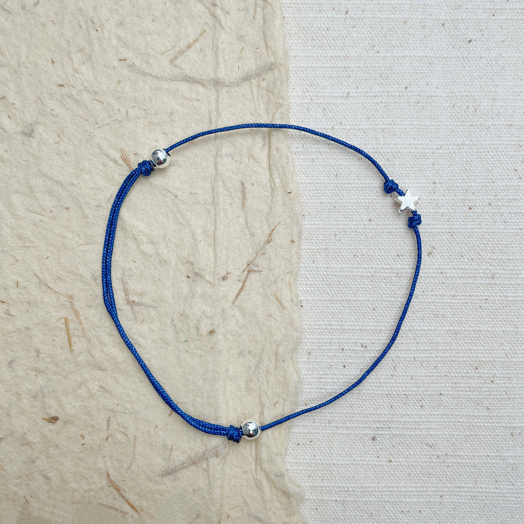 Handmade blue cord bracelet with silver star, minimalist boho jewelry.