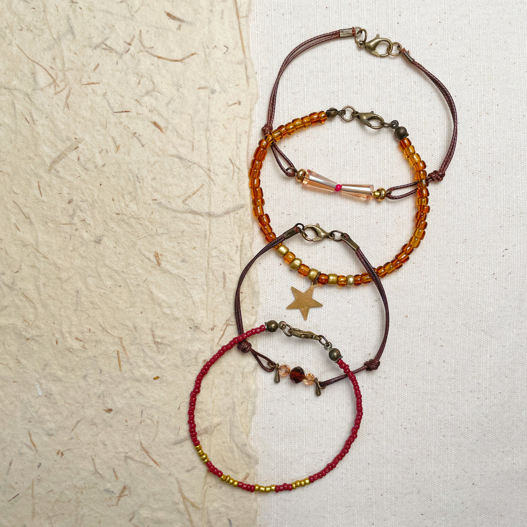 Handmade bohemian glass bead bracelet set with star charm, amber and gold jewelry.