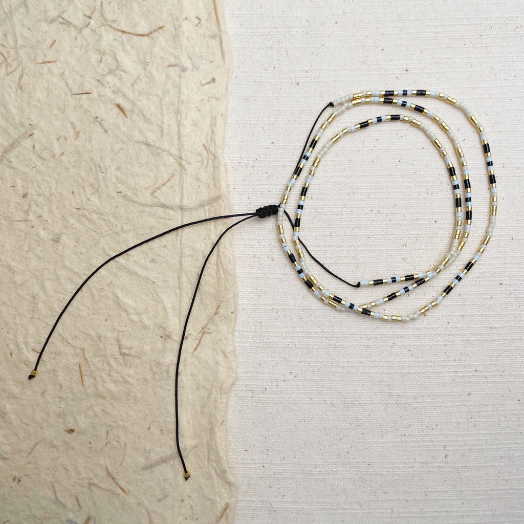 Handmade minimalist black and gold beaded wrap bracelet, seed bead boho jewelry.