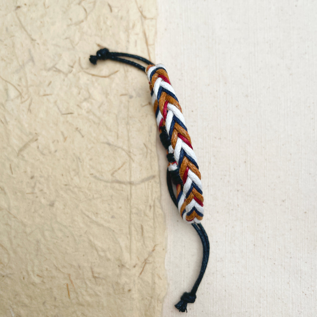 Colorful woven cotton bracelet on wrist, adjustable unisex friendship jewelry.