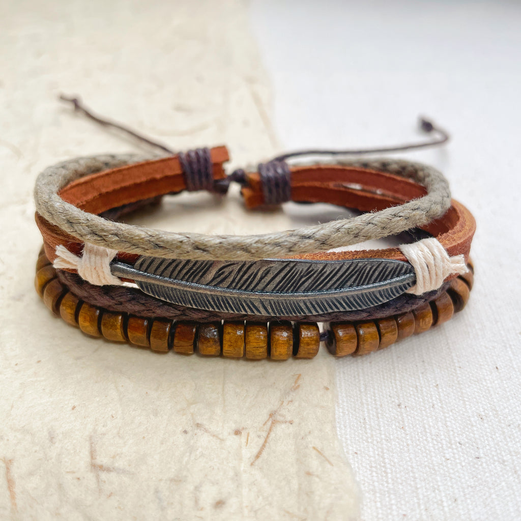 Handmade leather and wood beaded bracelet set with feather charm, boho mens jewelry.