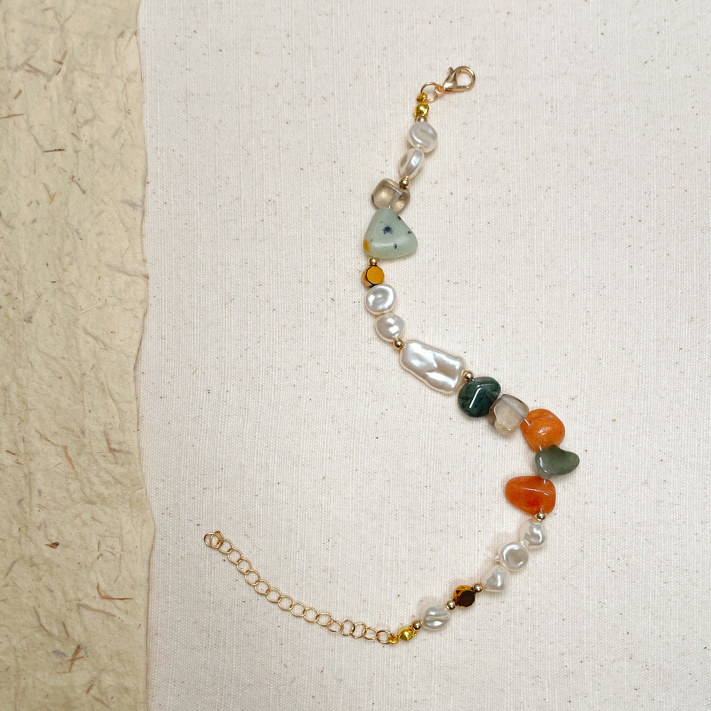 Mixed stone and pearl bracelet on wrist, adjustable soft earthy jewelry.