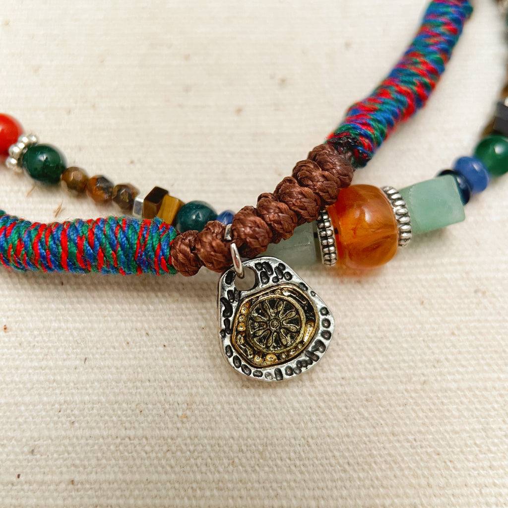 Colorful five elements protection bracelet on wrist, ethnic boho jewelry.